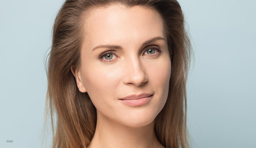 close up of a female face on a blue background 